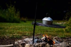 The camping kettle is over the campfire